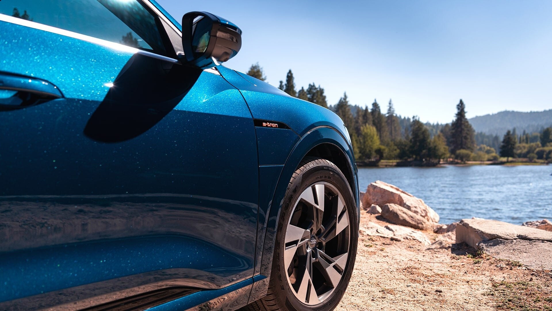 Blue Audi SUV side profile view.