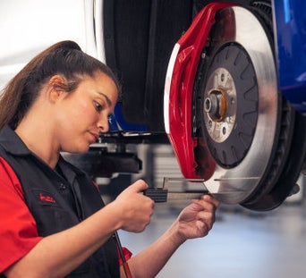 Service technician serving vehicle.