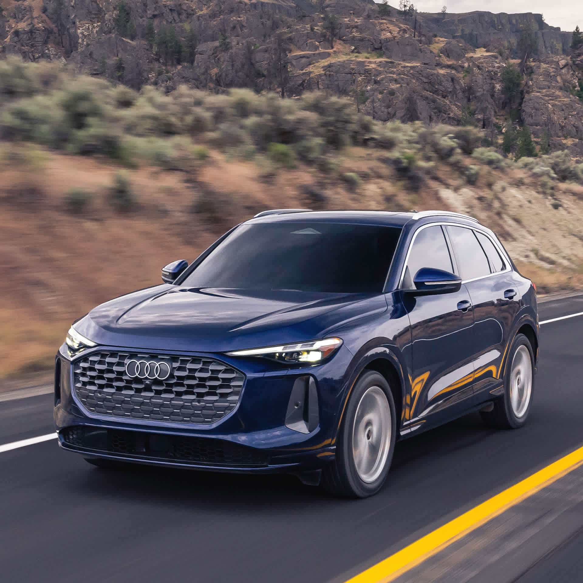 Left side profile view of an Audi Q5 driving