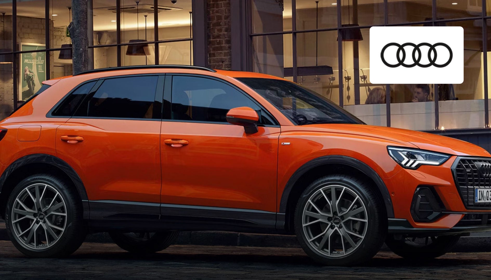 Audi Q3 parked in front of the Audi Dayton dealership, highlighting its bold compact SUV styling.