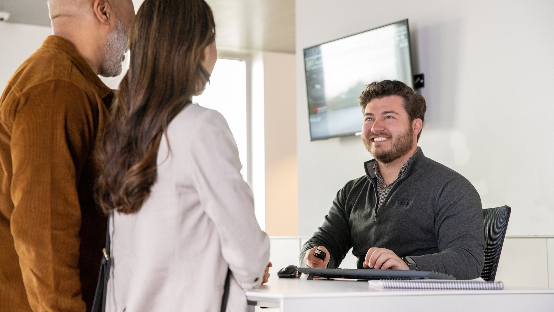 Audi representative talking to customers.