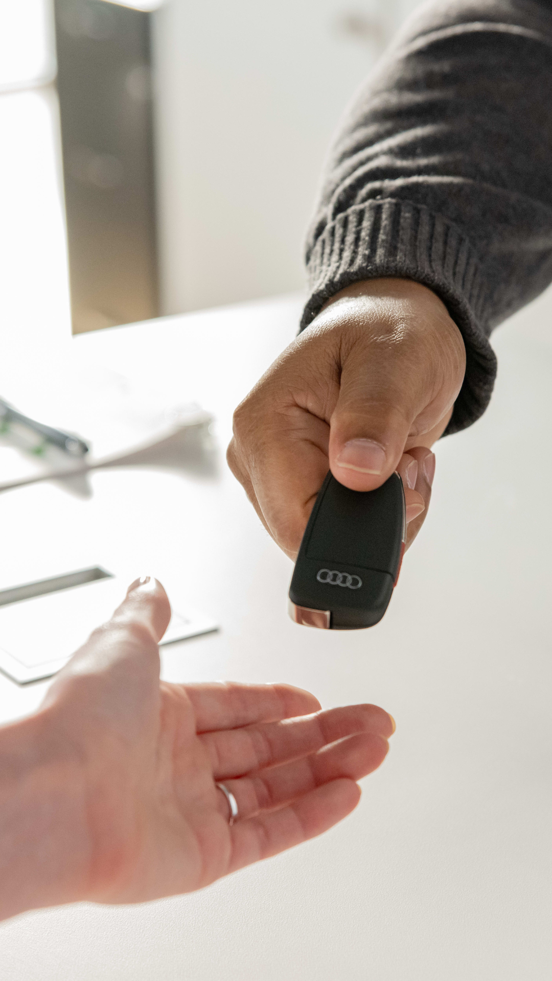 Handing over an Audi car key. 