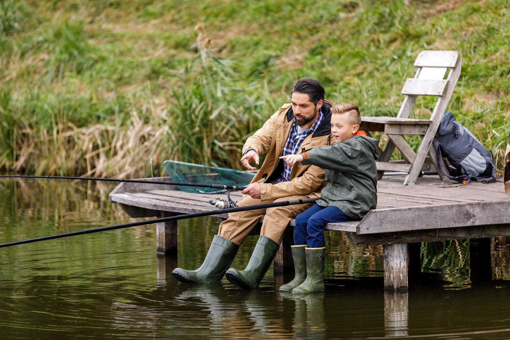 Man and Son Fishing on Dock