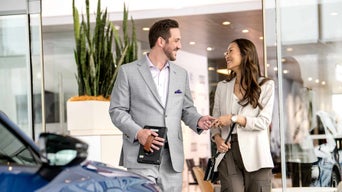 Audi sales rep handing keys to customer