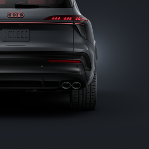 Close-up of the rear axle of the Audi SQ7 SUV with a focus on the right exhaust pipe and the 23-inch tire.
