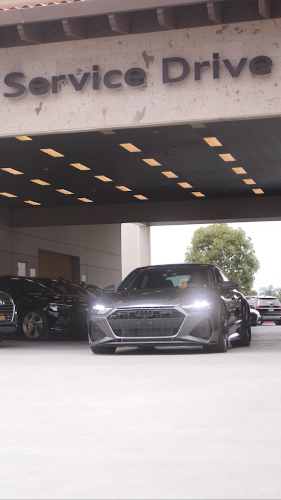 Front profile view of an Audi vehicle in the service drive.