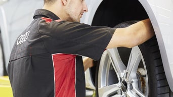 Service advisor taking a picture of a tire