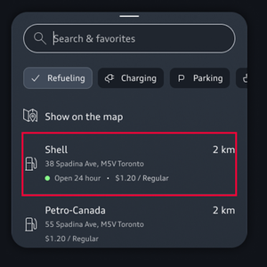 A search bar occupies the top of the screen while the destination details are highlighted at the bottom.