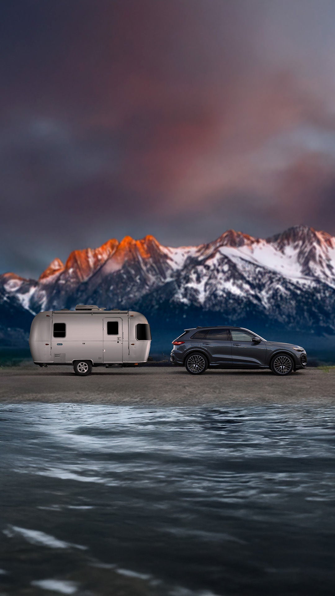 2025 Audi Q5 towing capacity shown pulling a Airstream Bambi at sunset in mountains