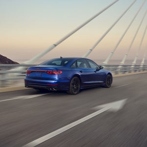 Rear 3/4 view of the Audi S8 in motion.