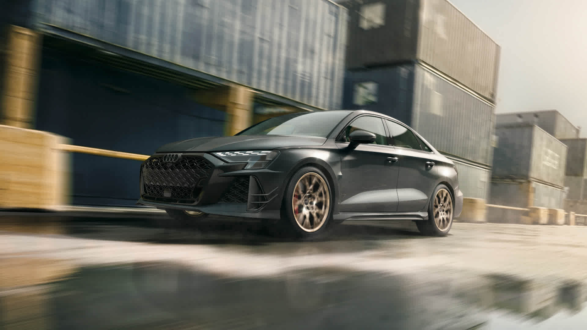 Three quarter view of an Audi RS3 accelerating.