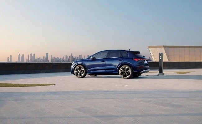 Audi Q4 e-tron parked in front of skyline