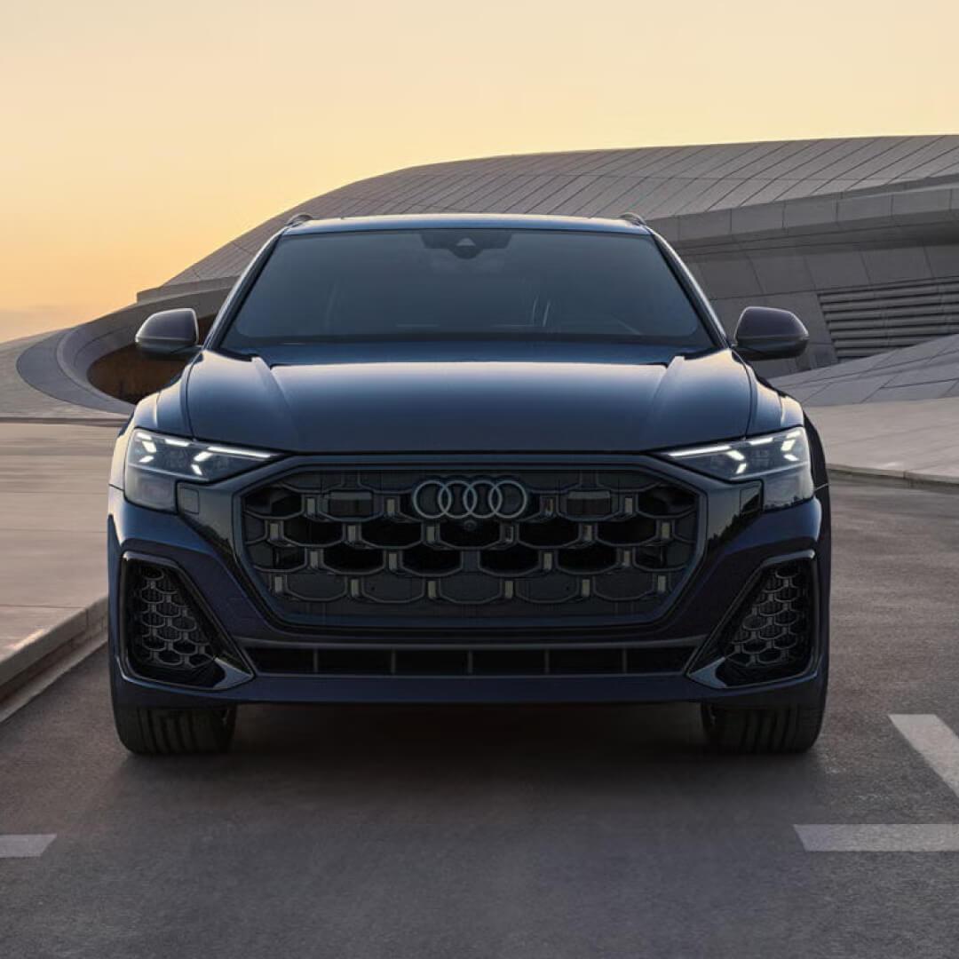 Head-on front exterior view of a black 2027 Audi Q8 showcasing its LED headlights and grille design.