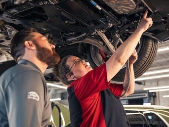 Service technician serving vehicle.