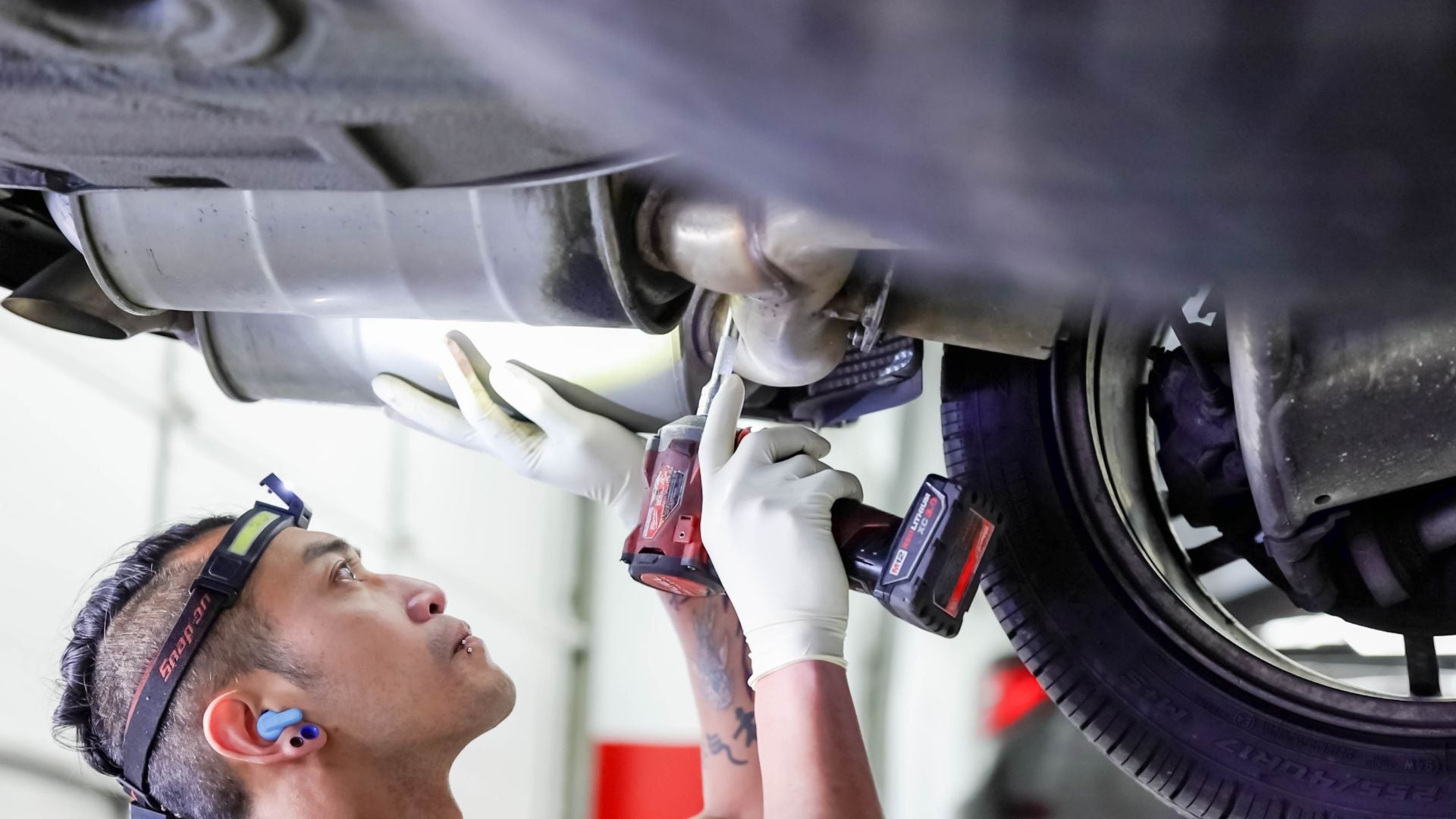 Audi service technician servicing a vehicle.