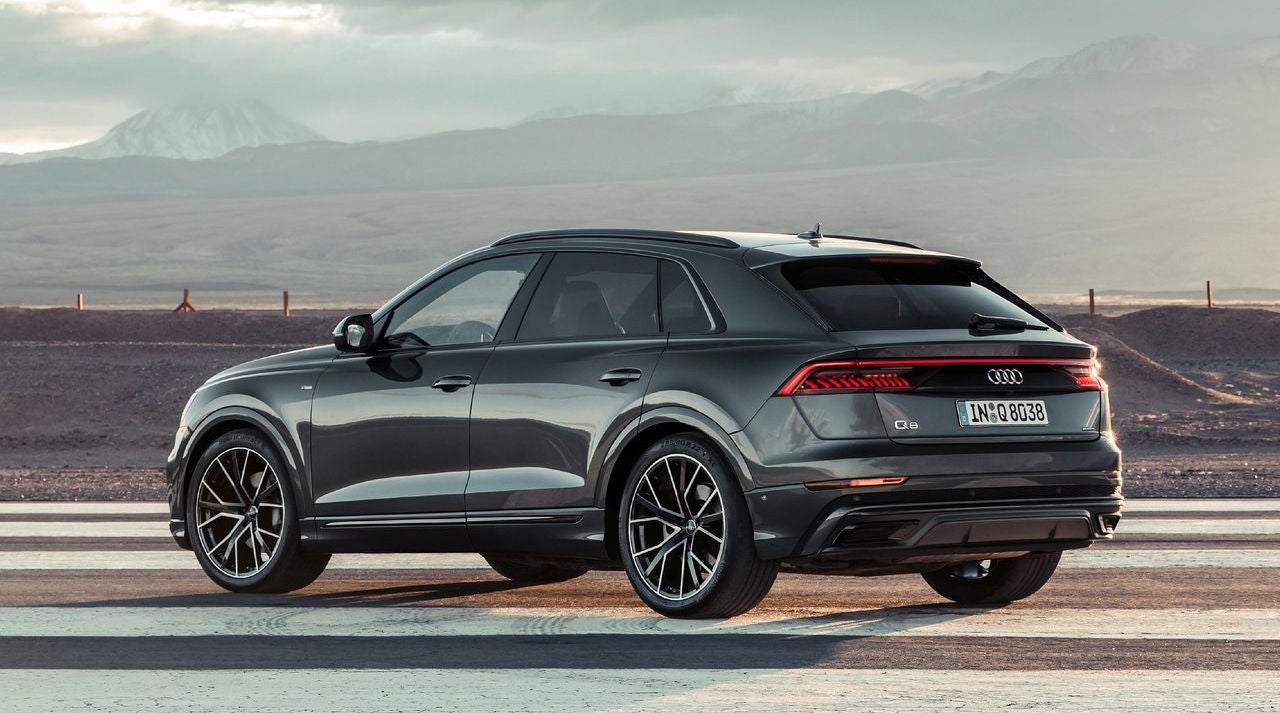 Right side profile view of an Audi Q8 SUV parked.