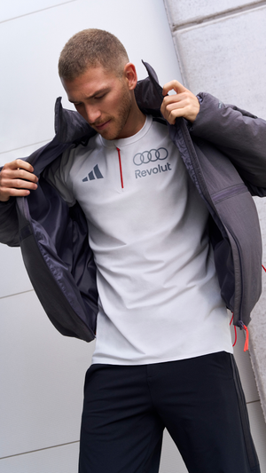 Close up of a man wearing a shirt from the adidas x Audi Revolut F1® Team collection