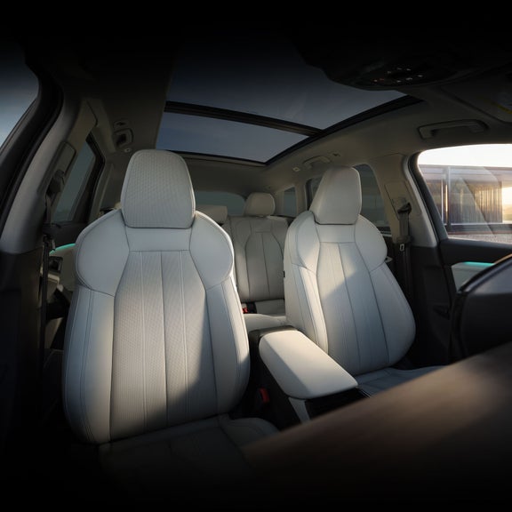 Interior view of the front seats in the Audi Q6 e-tron.