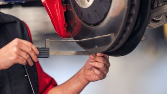 Service Technician measuring a wheel.