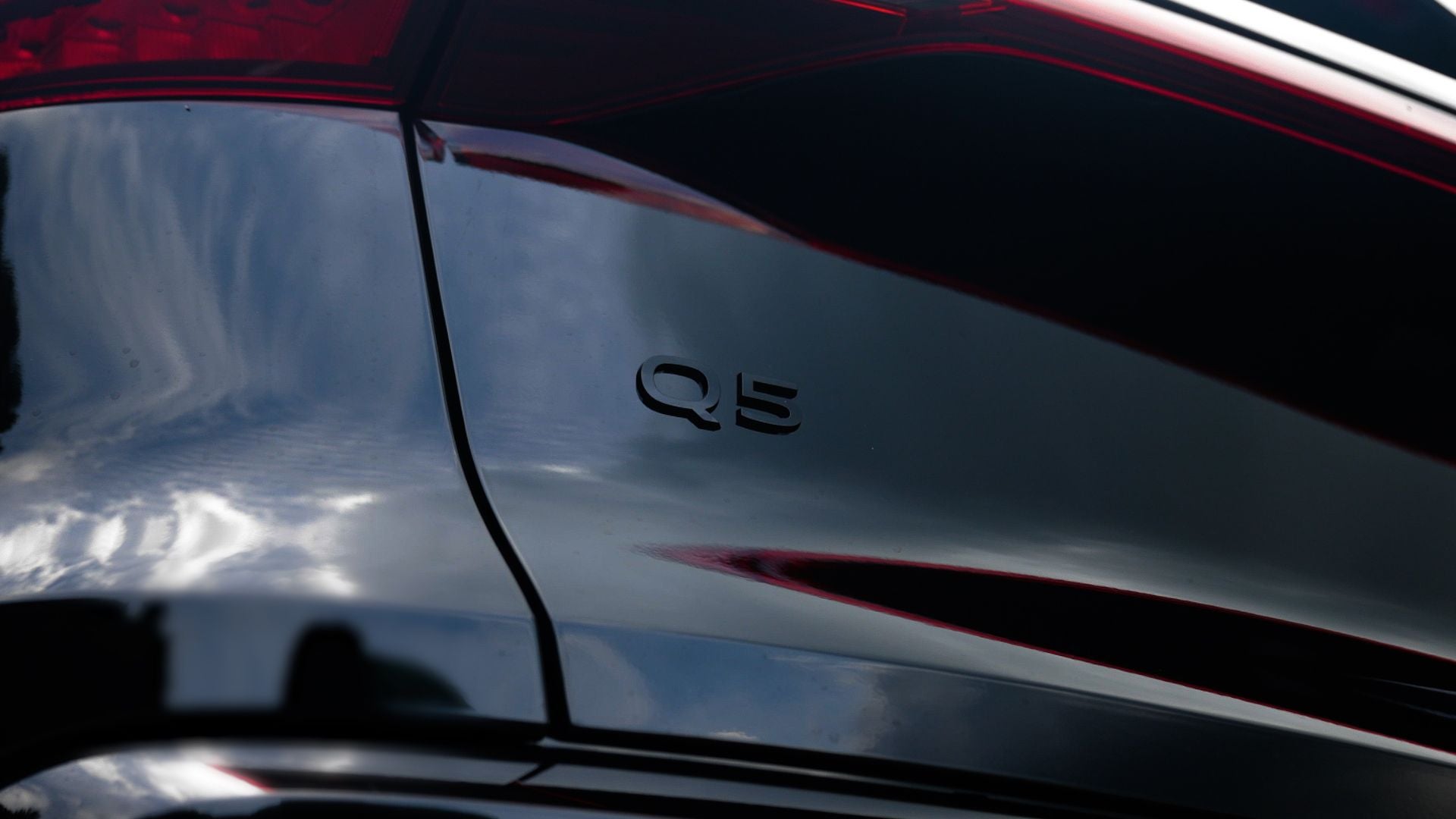 Close up of the back of a new Audi Q5, with the Q5 logo visible on the black car