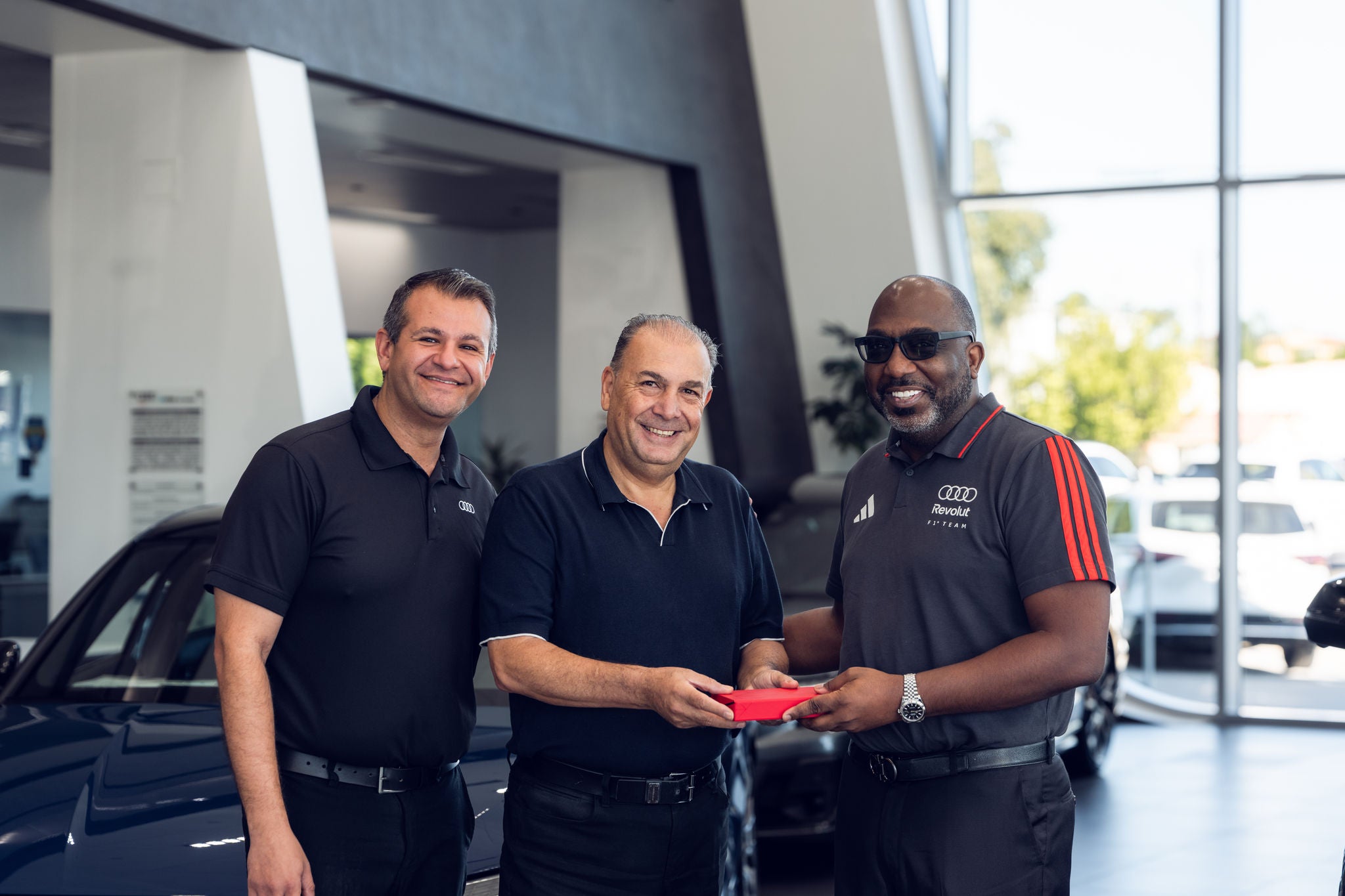 Audi employees standing in a group.