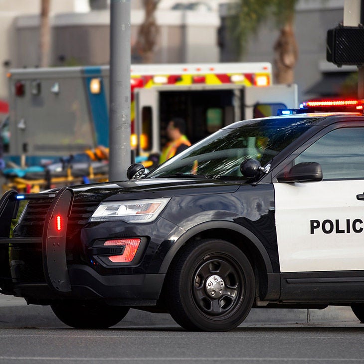 A police car parked in front of an ambulance.