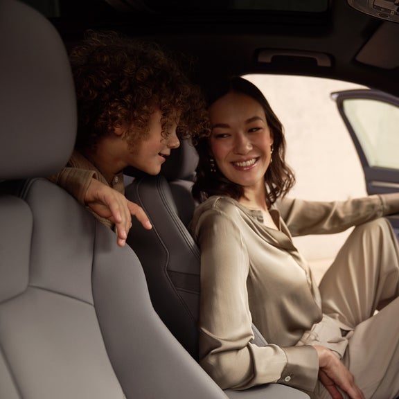 Audi owner and her child sitting in a leased Audi car.