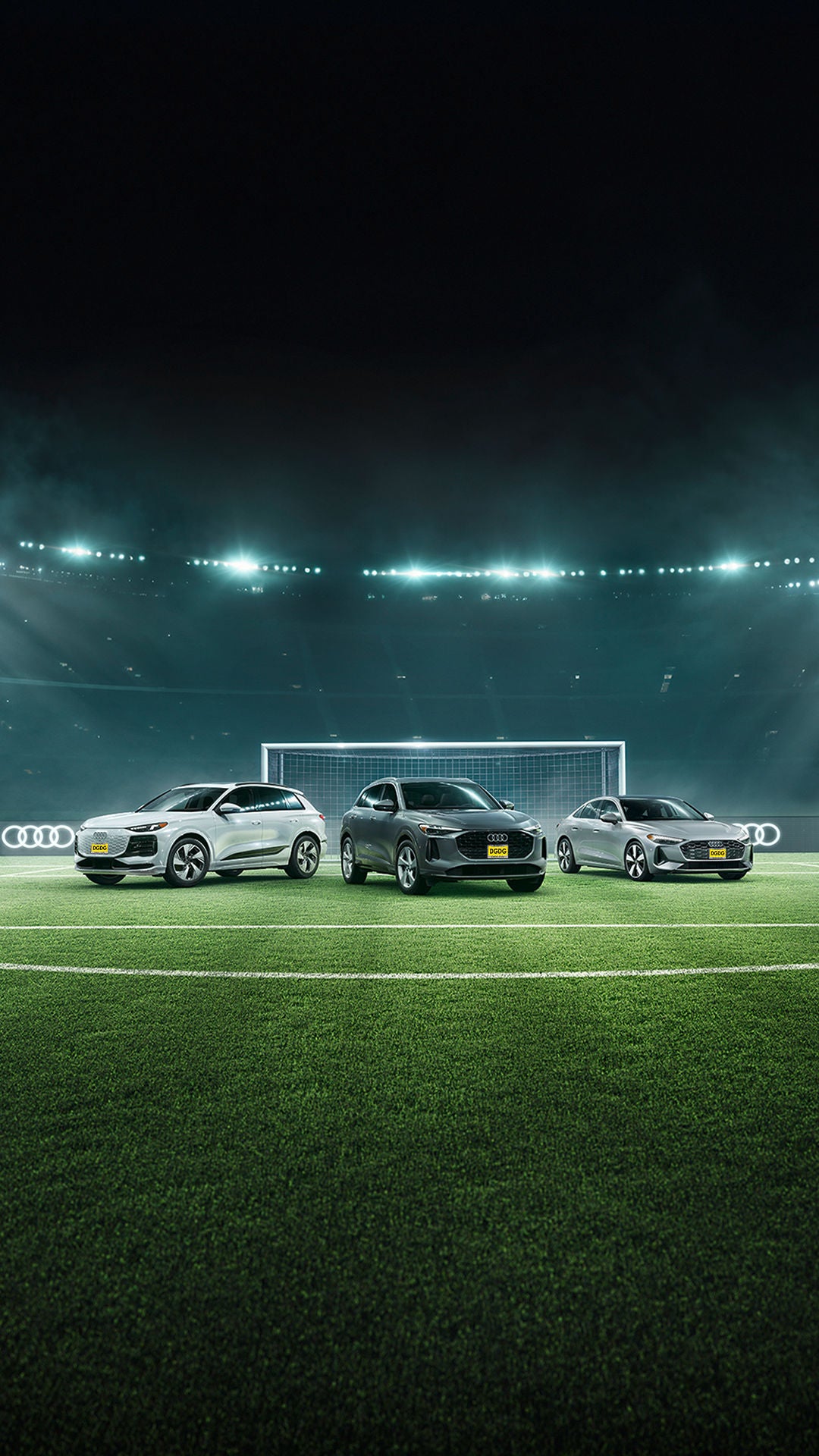 Three Audi 2025 vehicles parked in profile on a soccer field