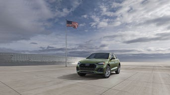 Audi suv with flag in background
