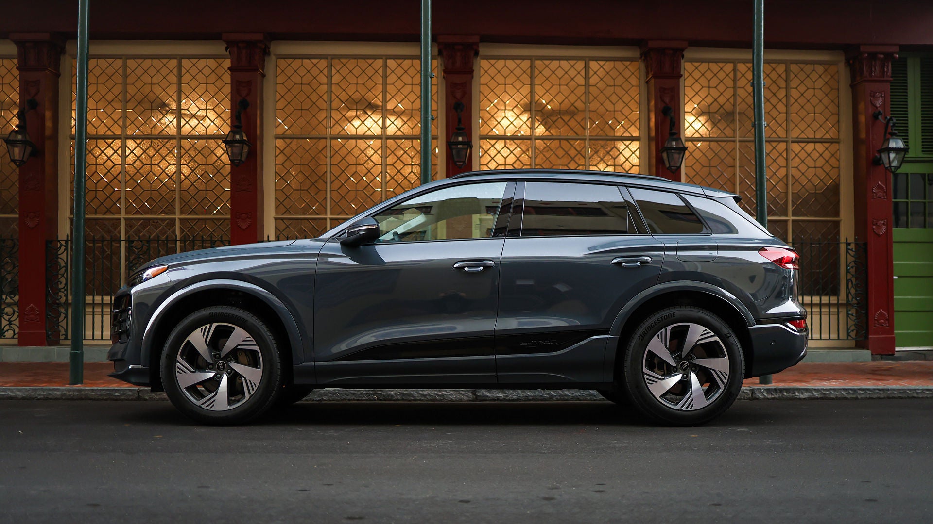 Audi employee handing a set of car keys to a customer.