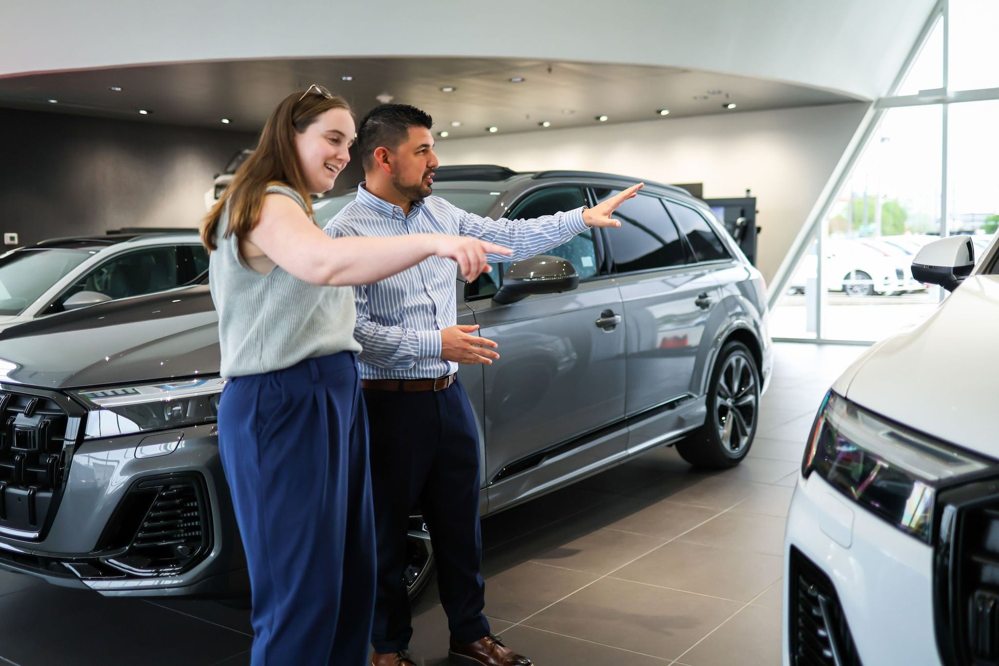 Audi salesperson discussing vehicle features with a client