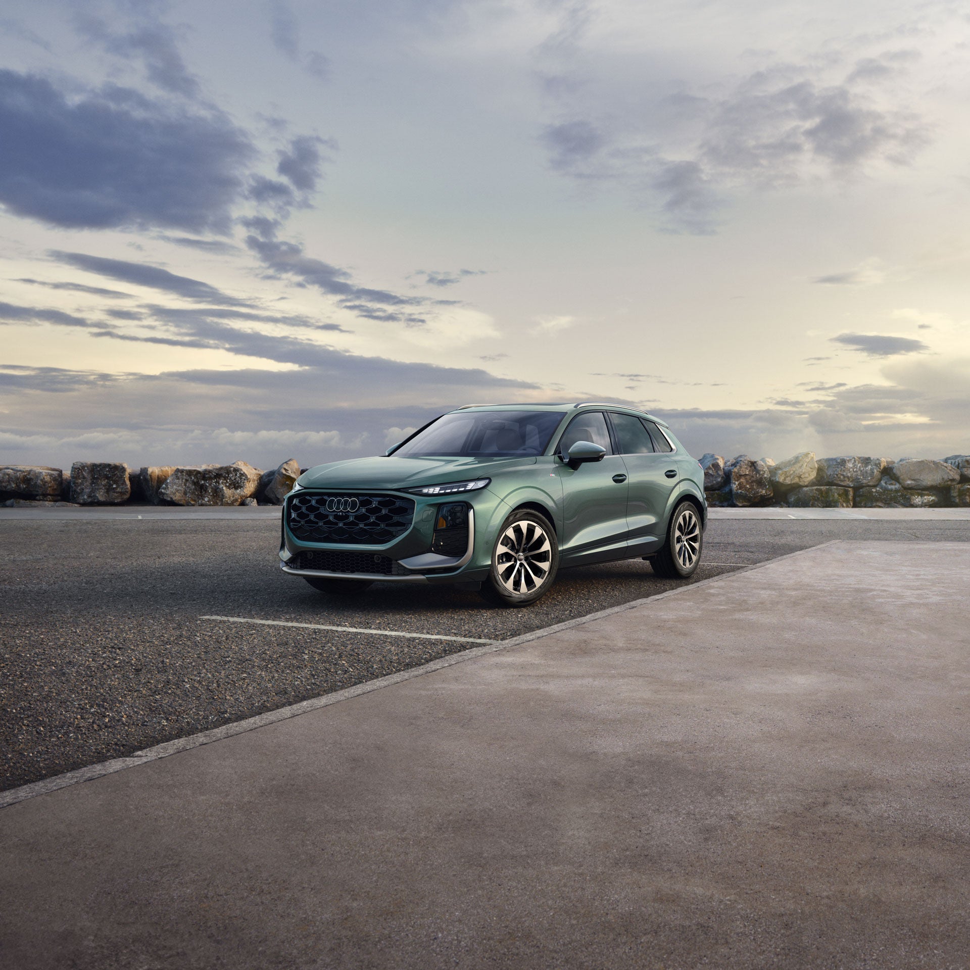 Three-quarter side profile of an Audi A6 accelerating.