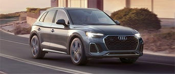 Three quarter view of an Audi Q5 driving.