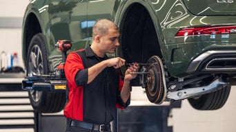 Audi Service technician servicing a vehicle.