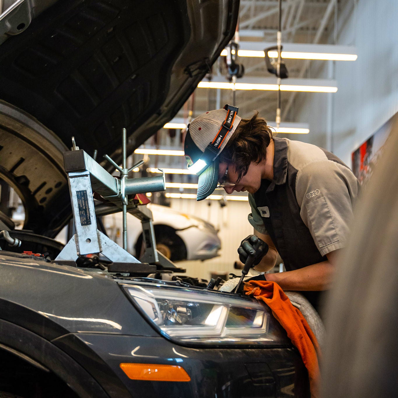 Un technicien du service Audi effectue l’entretien d’un véhicule. 