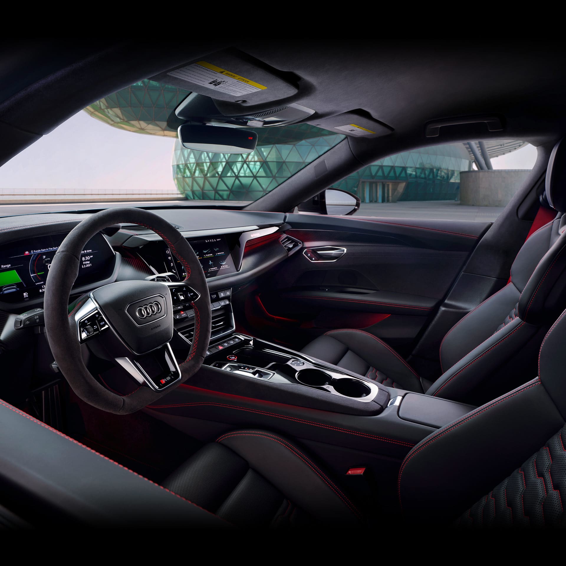 A full-shot photo of the interior of an Audi vehicle, including the dashboard, steering wheel, Audi virtual cockpit, and Audi MMI technology system display.