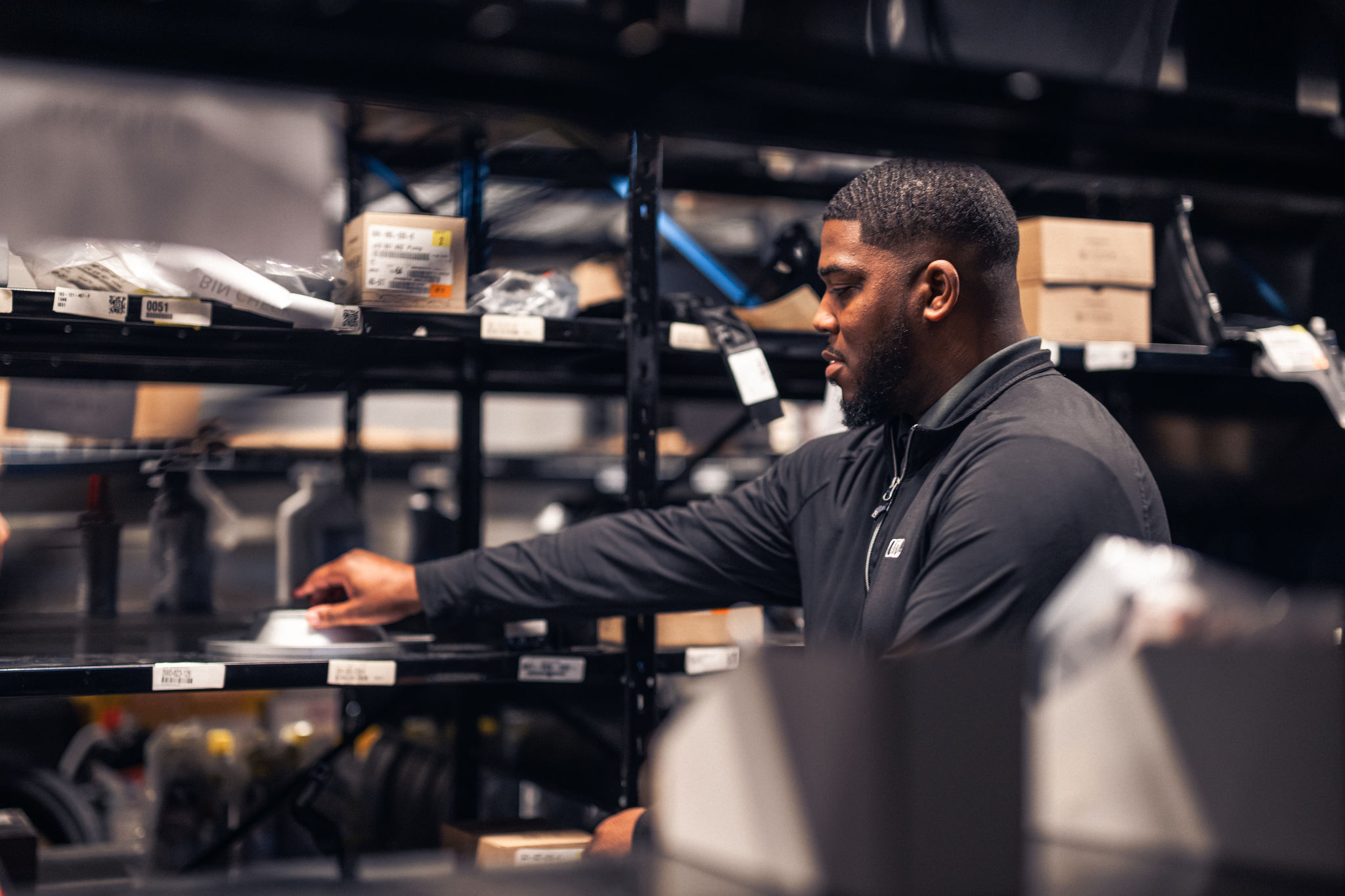 Audi service technician servicing a vehicle.