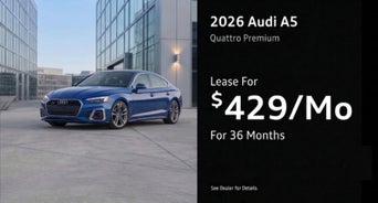 Three quarter view of an Audi A5 driving.