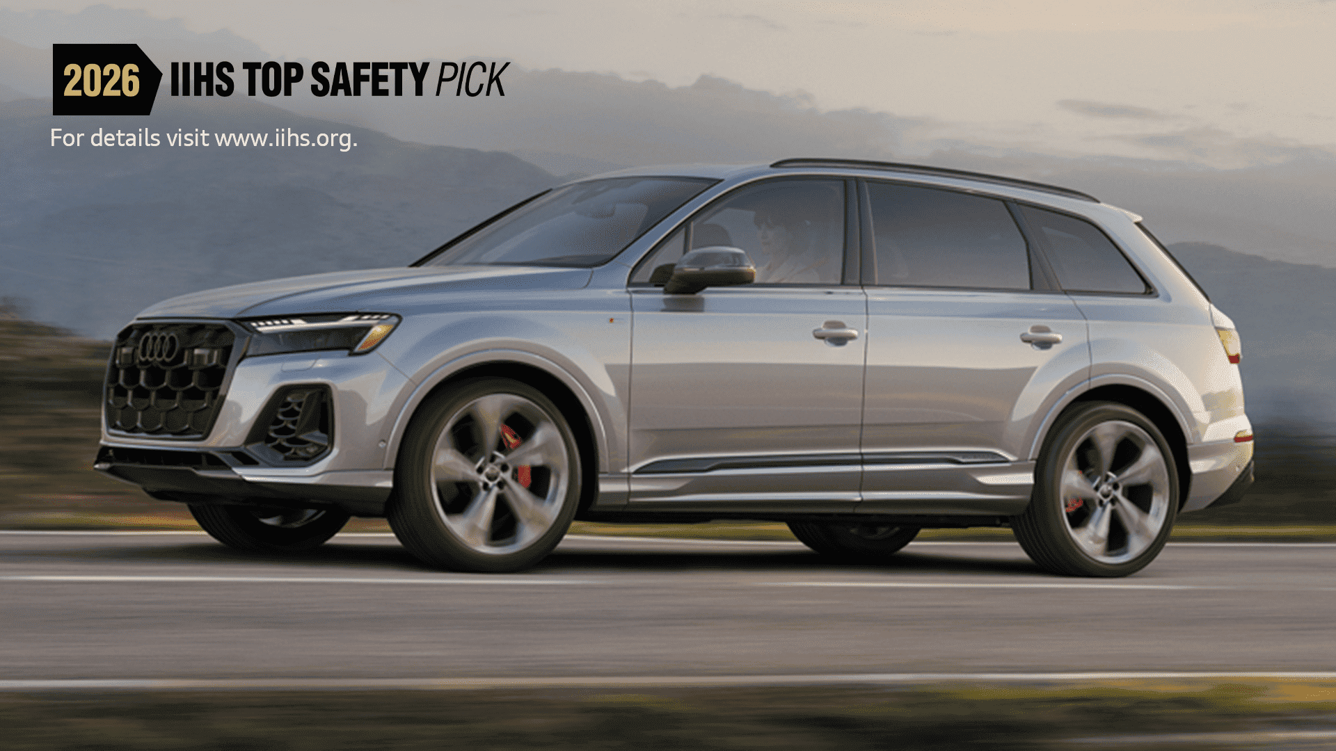 Side profile view of an Audi Q7 accelerating. 