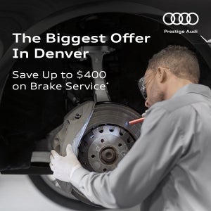 Audi technician inspecting brakes