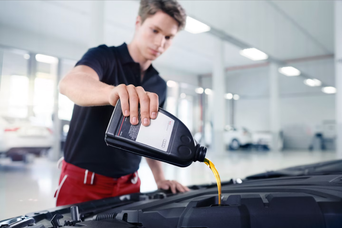 Audi technician servicing a vehicle 