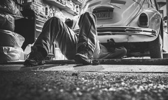 Service technician serving vehicle.