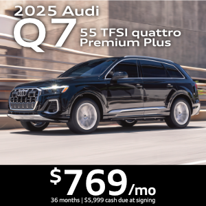 Side view of an Audi Q7 driving.