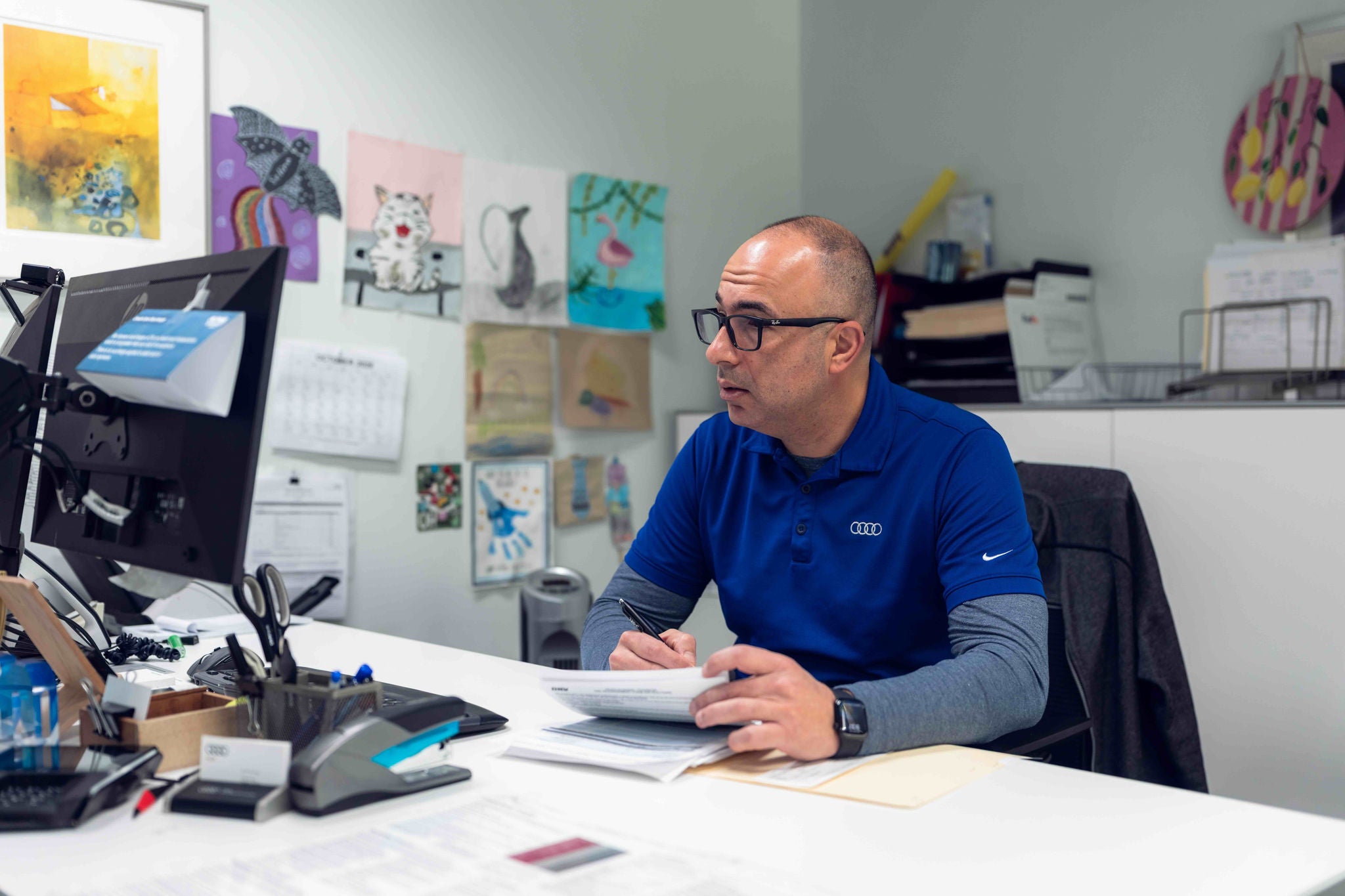 Audi Sale Specialist at their desk.