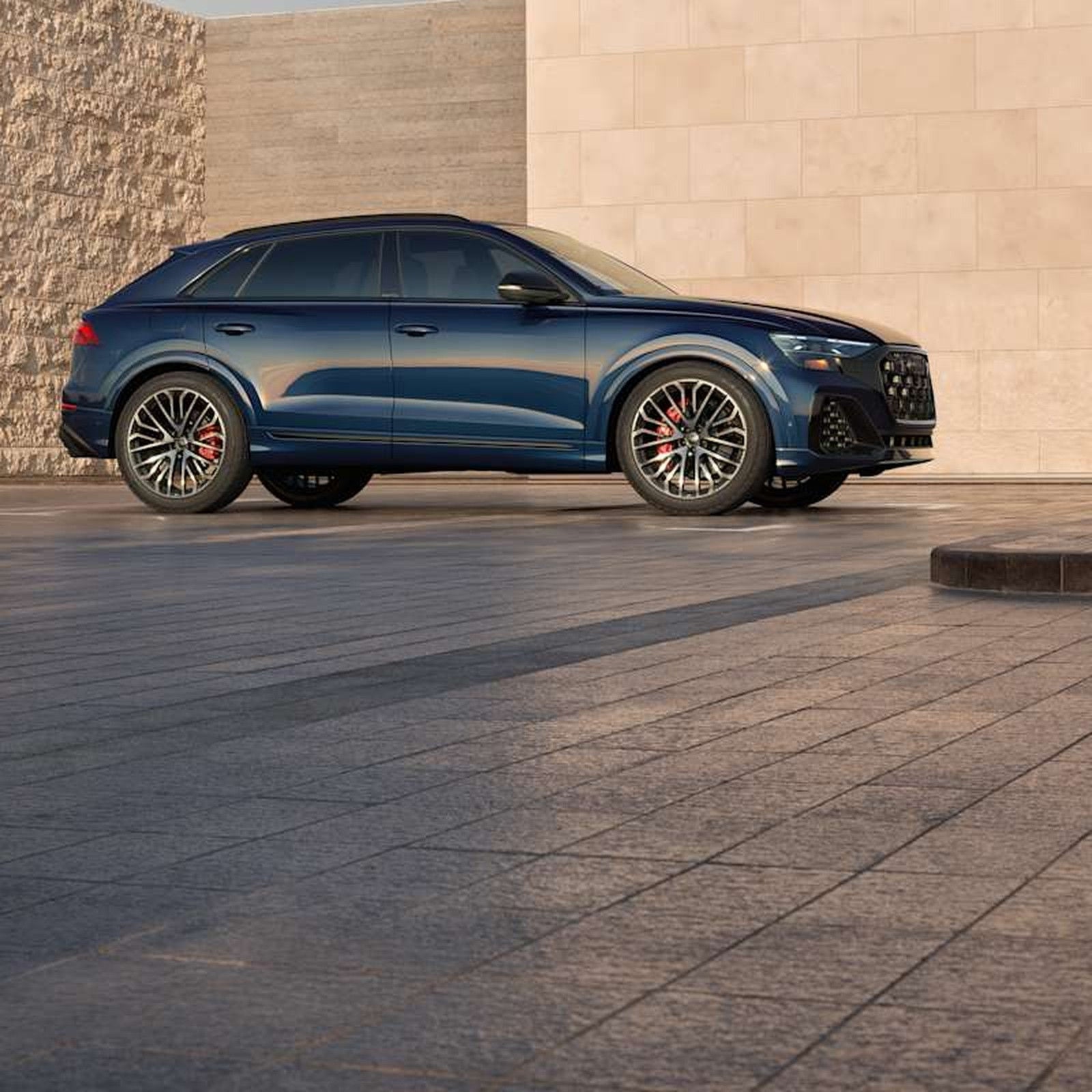 2026 Audi SQ8 driving, front three-quarter.