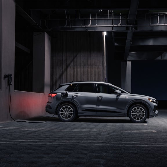 Side view of the Audi Q4 e-tron parked and charging.