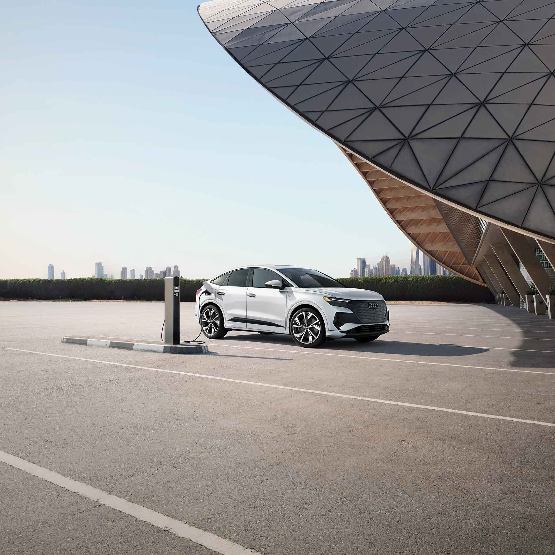 Front view of a range of Audi models in motion. 