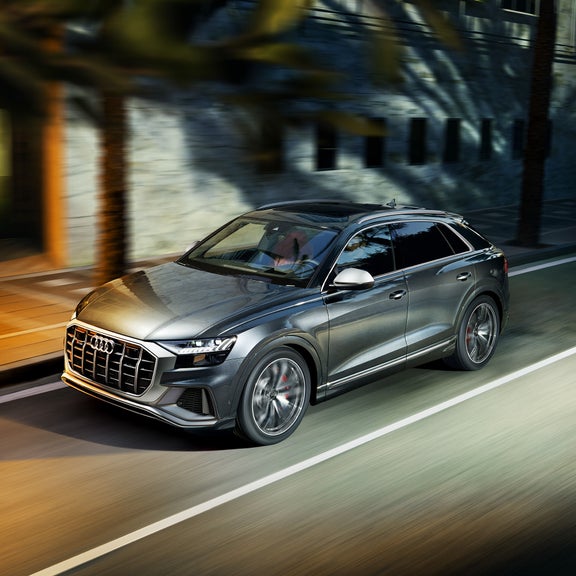 Three-quarter side view of the Audi SQ8 accelerating.