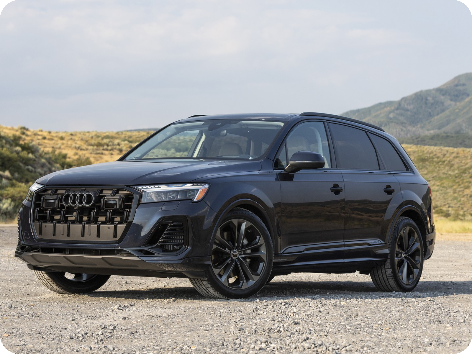 Audi Q7 in Waitomo Blue — three-row luxury SUV.
