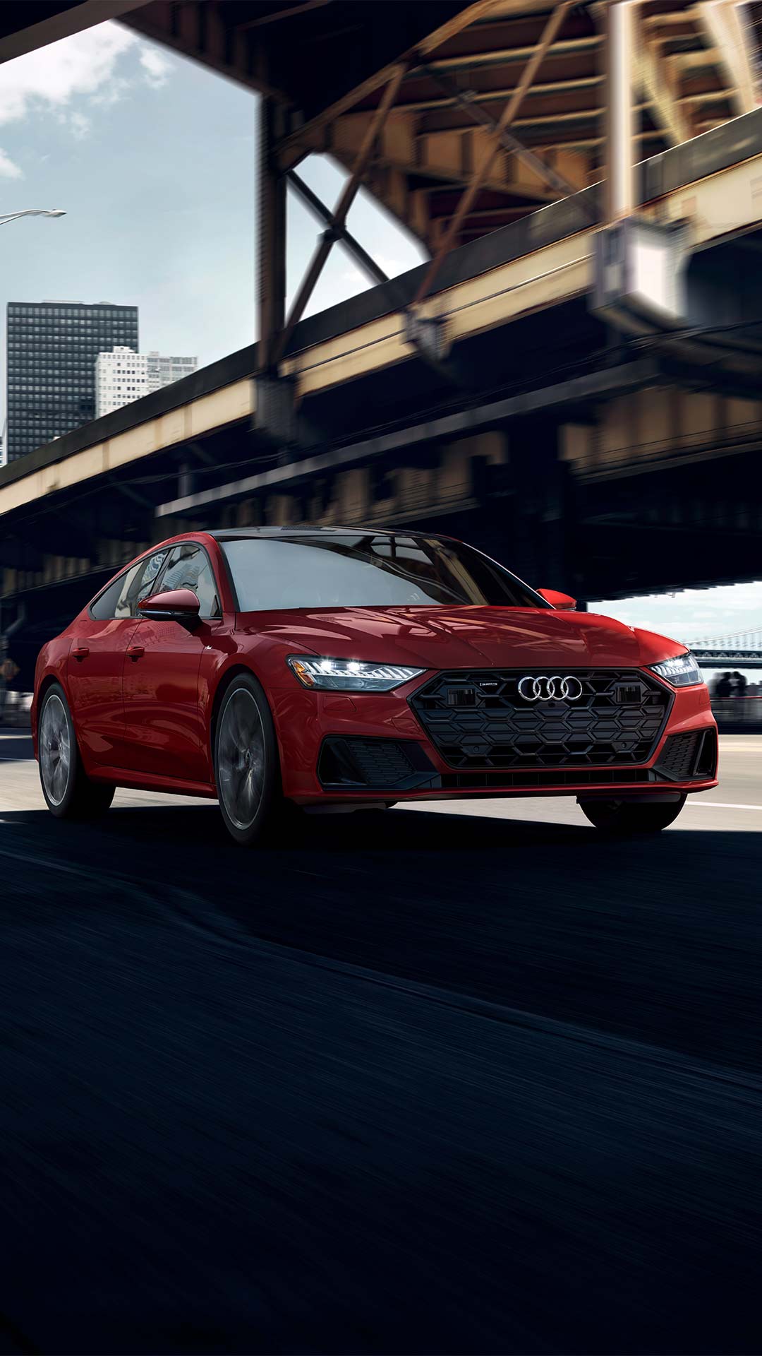 Front profile of Audi parked under Brooklyn bridge.